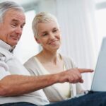 A retired couple review their investing portfolio
