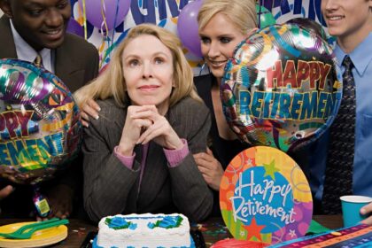 Content white businesswoman being congratulated by colleagues at her retirement party