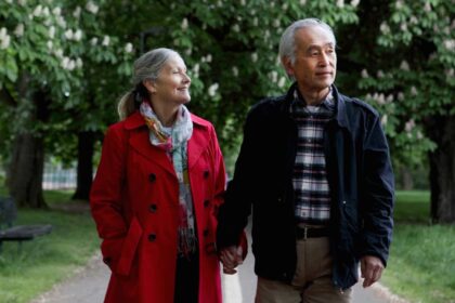 Older couple walking in park