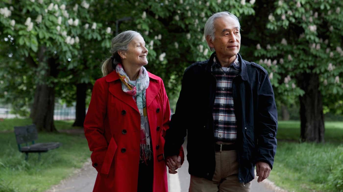 Older couple walking in park