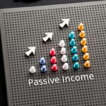 Passive income text with pin graph chart on business table