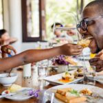 A Black father and daughter having breakfast at hotel restaurant